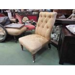 A Victorian nursing chair with gold silk upholstery,