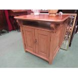 A pine double cupboard door unit with carved scroll supports,