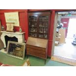 An Edwardian bureau bookcase with glazed top and drop flap over three drawers on cabriole legs,