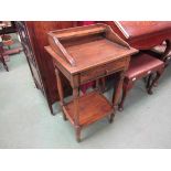 An oak single drawer side table with gallery back and under tier,