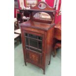 A late Victorian rosewood music cabinet with raised gallery back over astragal glazed door on