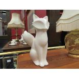 A stylised figure of a white glazed fox,