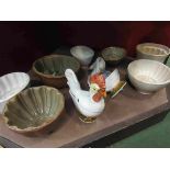 A selection of jelly moulds, chicken design egg crocks etc.