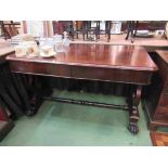 A William IV rosewood library table the two frieze drawers over a lyre end base joined by a turned