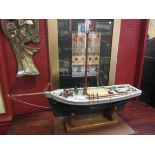 A hand built model ship "Flora" on display stand,