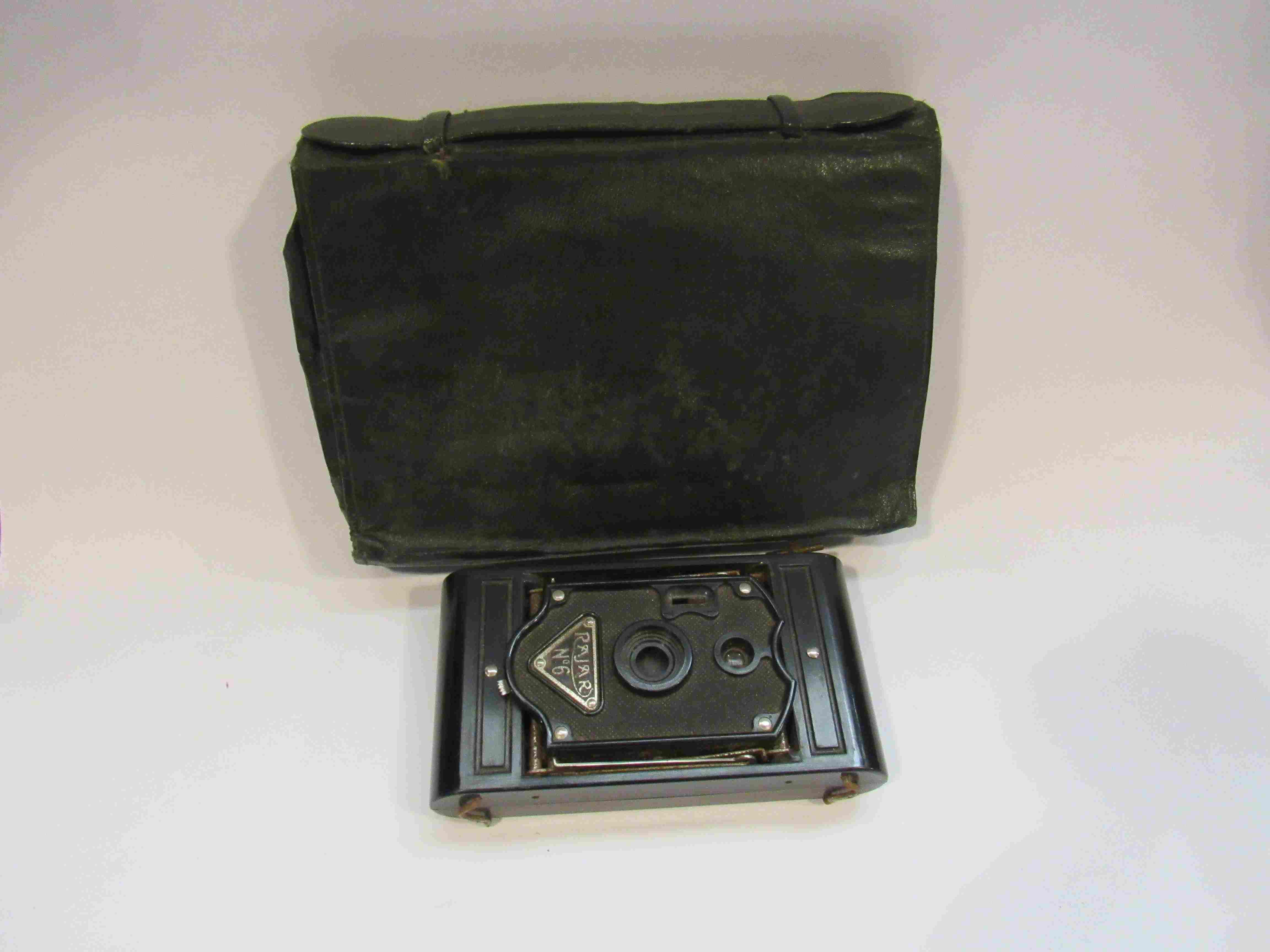A leather clutch bag and a Rajar camera