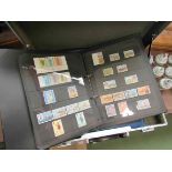 A stamp album with contents and a folder of First Day covers including Hong Kong