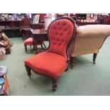 A Victorian walnut buttoned spoon back armchair over a serpentine front seat on turned legs and