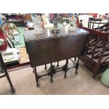 An Edwardian mahogany Georgian style occasional table the rising leaves over ring turned cabriole