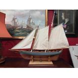 A hand built model boat on stand "The America" with related ephemera etc,