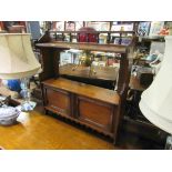 A late Victorian walnut wall hanging shelf with turned spindle gallery over two doors with key,