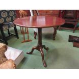 A 19th Century mahogany and oak circular tilt top wine table on cannon barrel turned column and