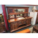A late Victorian oak mirrored back sideboard with cupboard and drawer base,