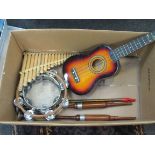 A ukulele, two wooden chanters, penny whistle, pan pipes and two tambourines