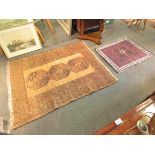 A mustard ground geometric rug and a smaller rug