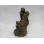 A brown glazed plaster figural group of nude couple embracing,