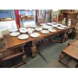 An oak extending leaf dining table on baluster legs and stretcher base,