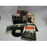 A Beatles stamp cover, picture with autosign signatures, two books and seven 7" singles/ EPs,