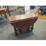 An oak drop-leaf coffee table