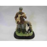 A Leonardo Collection painted resin figural group of shepherd feeding a lamb,