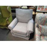 A powder blue armchair with fern leaf pattern,