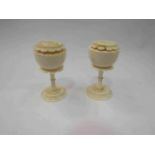 A pair of antique ivory salt and pepper shakers