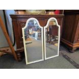 A pair of arch top painted mirrors,