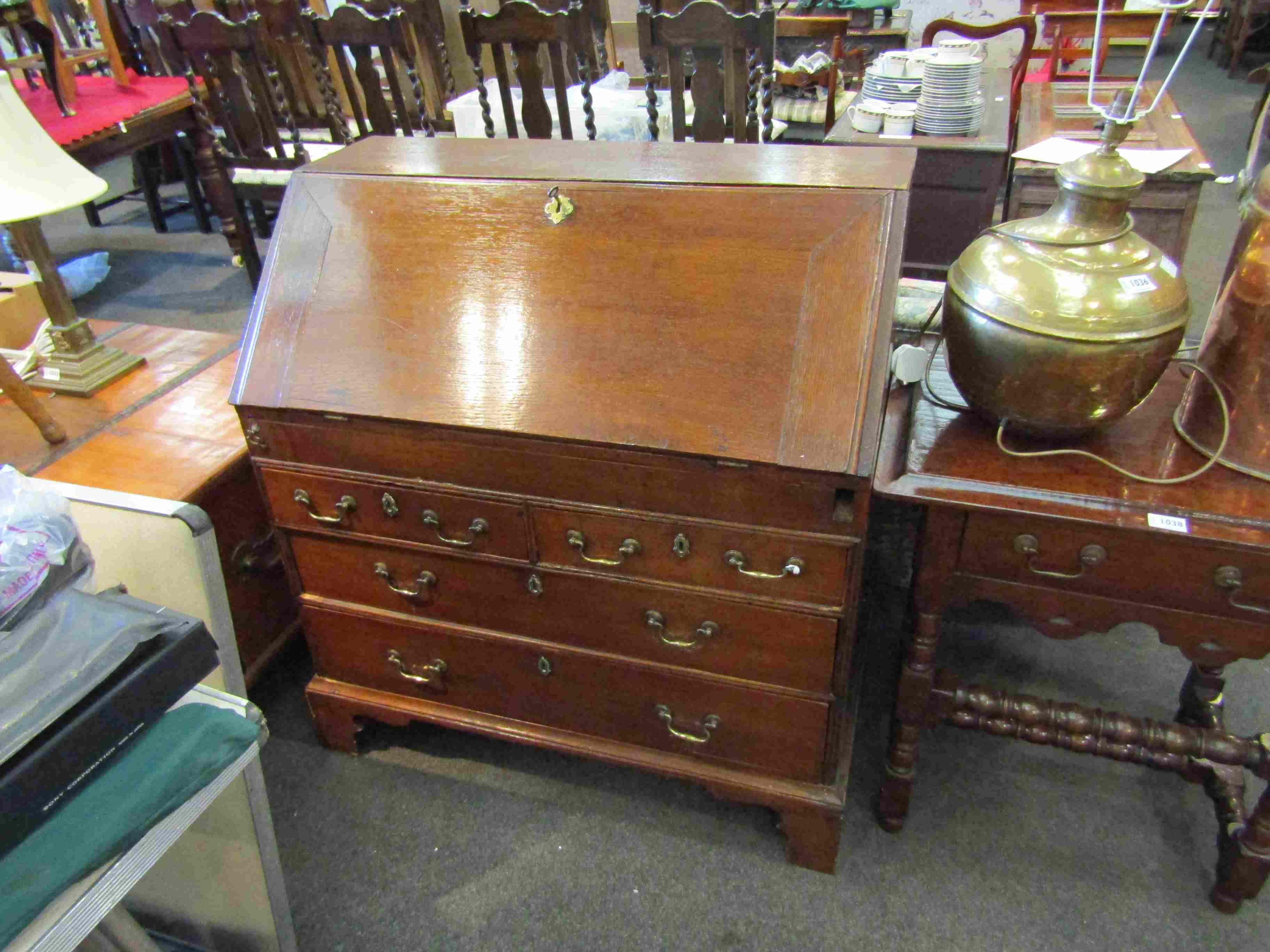 A 19th Century oak drop flap bureau with fitted interior and a two over two chest on bracket feet,