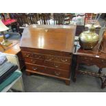 A 19th Century oak drop flap bureau with fitted interior and a two over two chest on bracket feet,