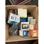 A box containing a collection of lenses and accessories including Schneider enlarger lens and