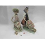 Two Lladro figures girl and boy with wheel barrow full of flowers