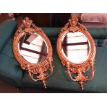 A pair of gilt girandole mirrors