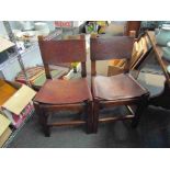 A set of six oak and leather dining chairs with brass stud work