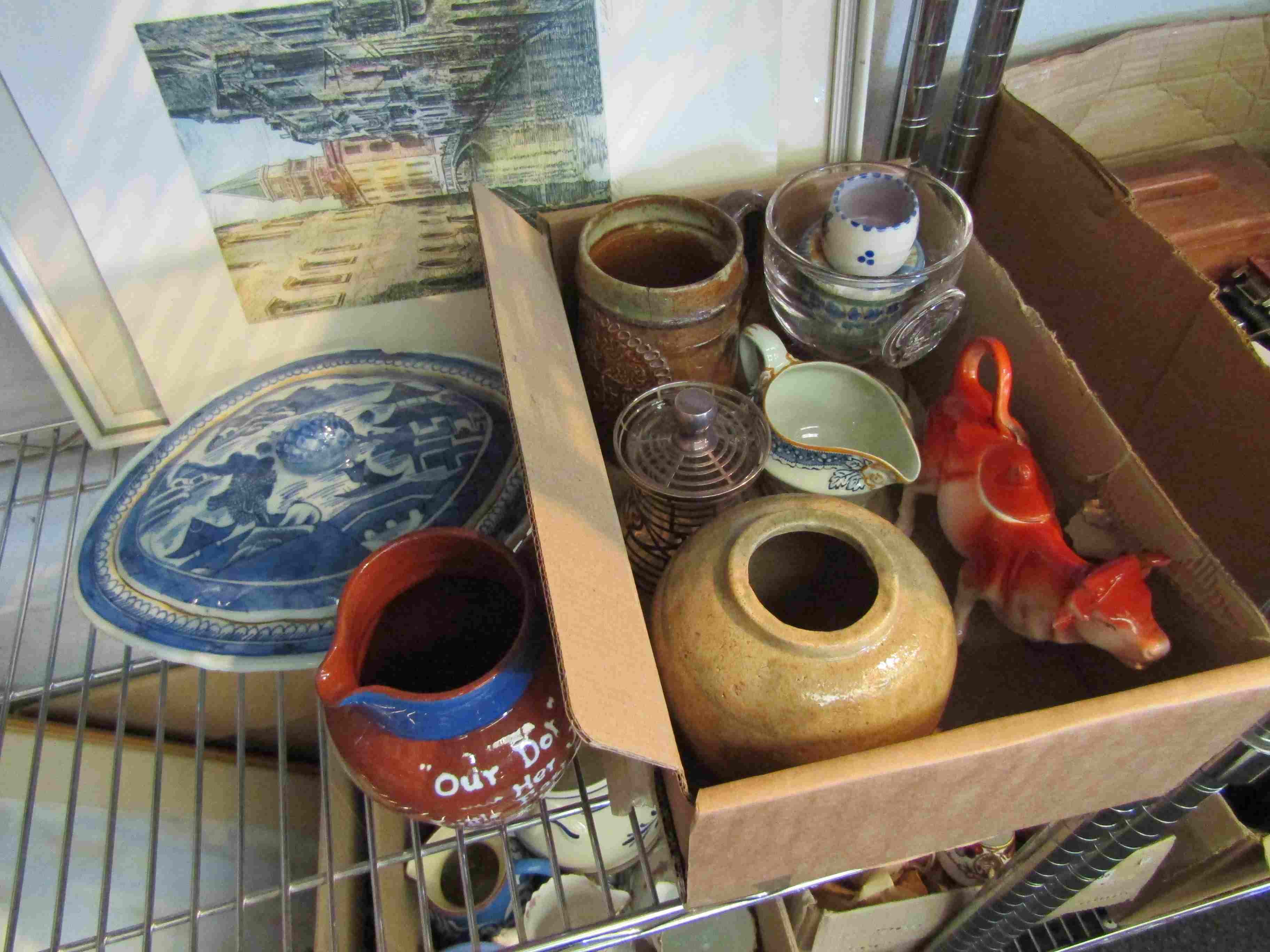 A box of assorted pottery including cow creamer,