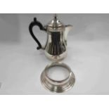 A silver lidded jug with ebonised handle, London, and a silver dish ring,