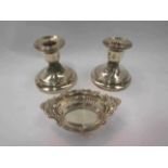 A pair of silver squat form candlesticks and miniature dish (3)