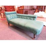 A late Victorian/early Edwardian chaise longue with green swag upholstery on ring turned legs to