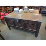 A late 17th/early 18th Century carved oak coffer, split pin hinges, carved panel front,