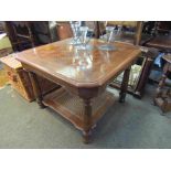 A square wooden coffee table with rattan undertier,