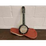 An unbranded banjo-ukulele / banjolele with soft case
