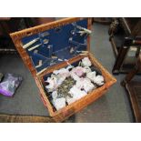 A picnic basket with eight table decorations and candles