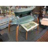 Two modern graduating glass top oval tables