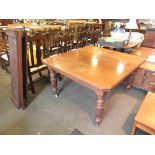 A Victorian mahogany telescopic dining table on finely fluted baluster legs with three extra leaves