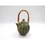 A Studio pottery teapot with cane handle.