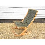 GEORGE SNEED (b.1927) - A pine framed rocking chair with leather strap seat and back.