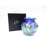 An Okra glass vase designed by Dave Barras, blue with iridescent floral detail.