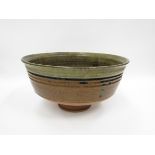 An oversized studio pottery bowl, green glaze, 19cm high x 36.