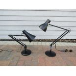 A pair of black anglepoise lamps
