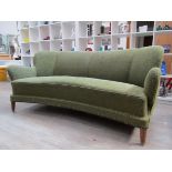 A 1940's Danish three seater sofa with curved front, original green embossed scroll upholstery.