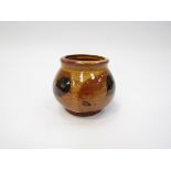 BERNARD LEACH (1887-1979): An earthenware small pot with ochre wash and black splash detail.